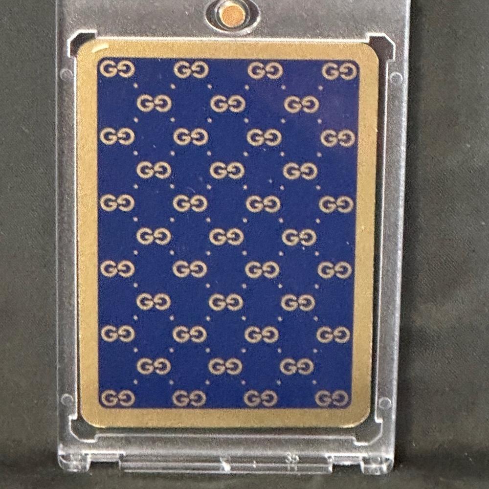 1Gucci playing card 9 of hearts. Navy blue/gold. enclosed case